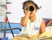 child playing imagination pirate game with cardboard